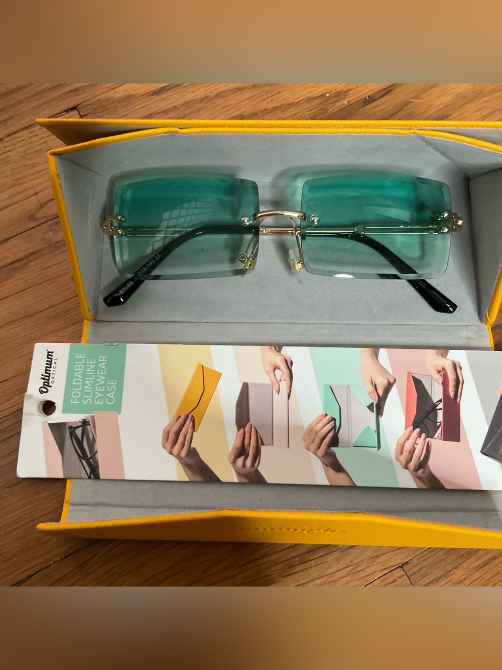 NWT yellow Optimum Optical eyeglass holder w/ green-tinted frameless sunglasses